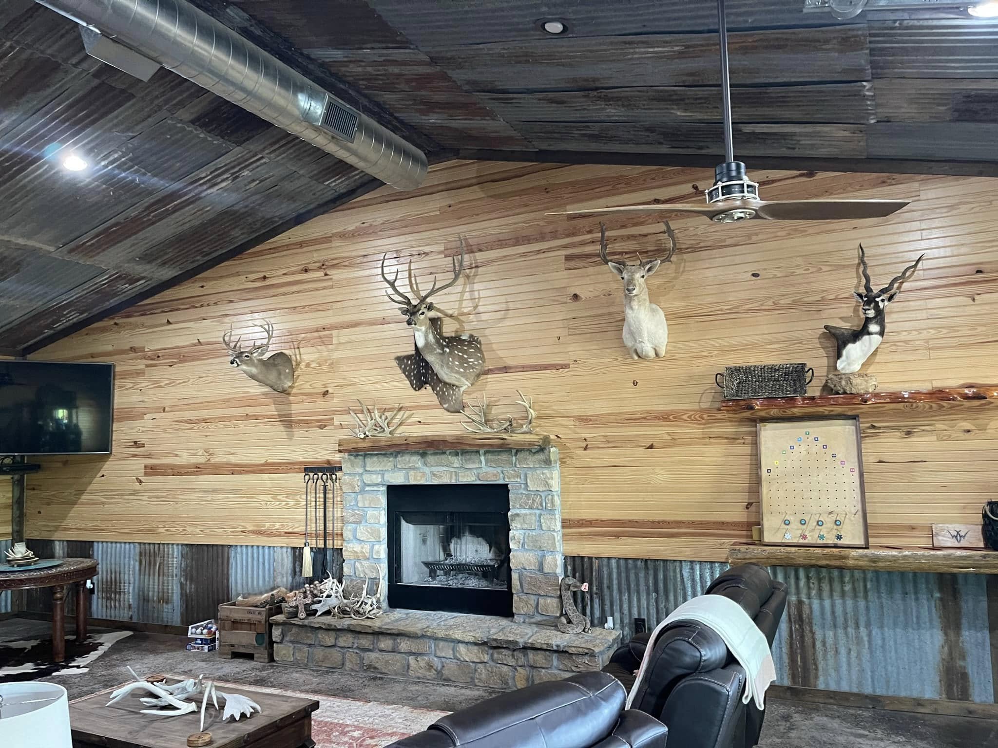 Stone fireplace and trophy display inside the WOW Ranch lodge