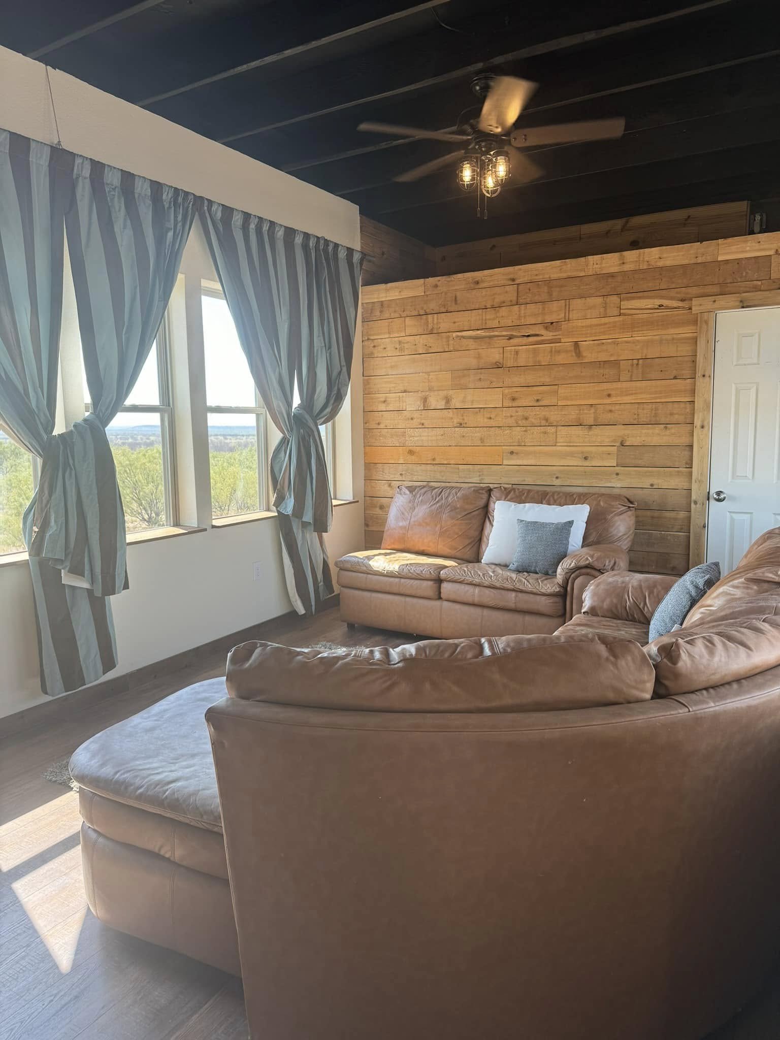 Sunset Cabin lounge with leather seating and ranch views